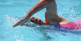 Female student swimming a lap